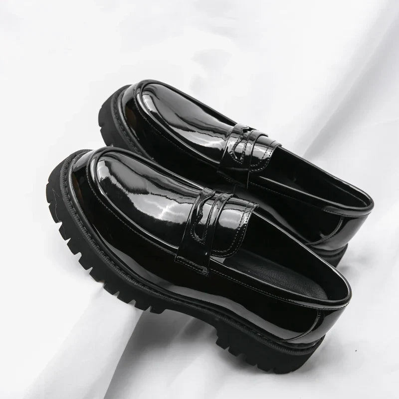 Stylish men's black loafers with a modern chunky sole. Comfortable slip-on dress shoes for versatile fashion footwear.