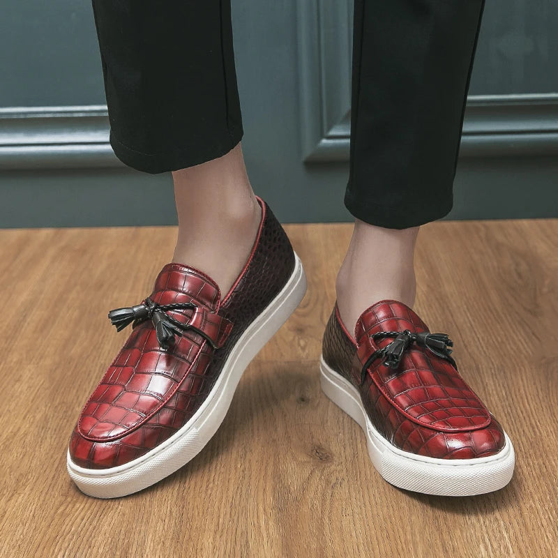 Stylish men's loafers with croc embossed leather and decorative tassels, side view
