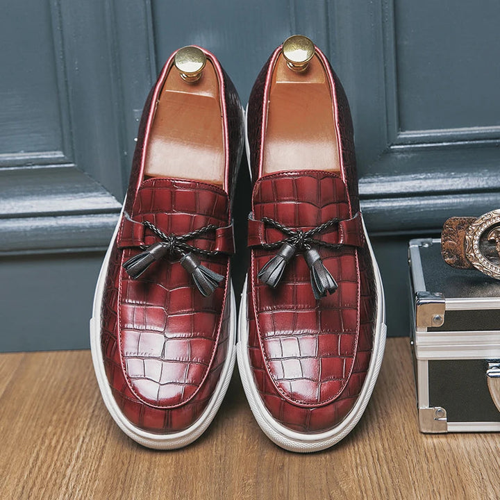 Front view of men's leather tassel loafers featuring a distinctive croc embossed texture