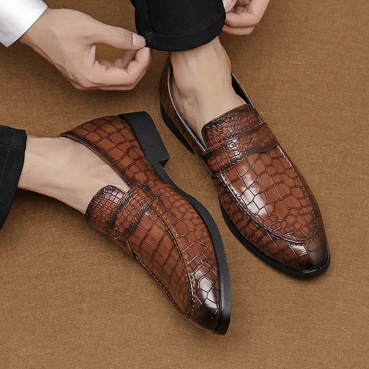 Pair of men's luxurious crocodile embossed slip-on loafers, perfect for dressy occasions
