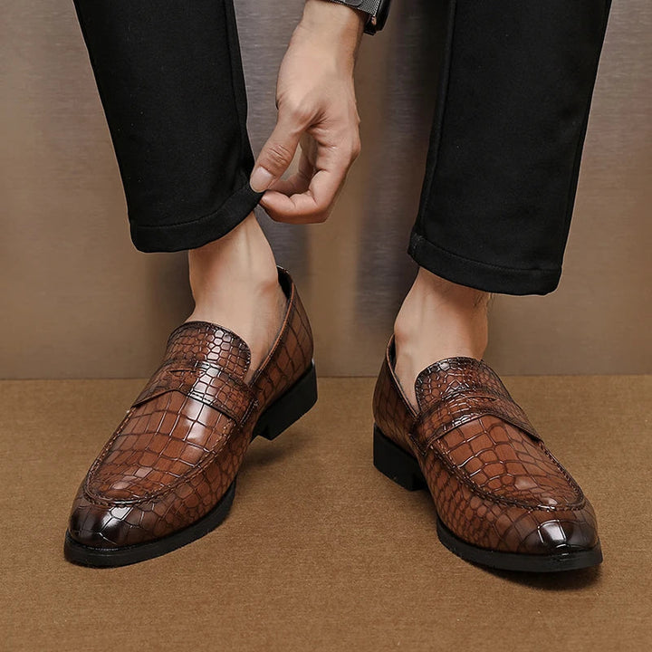 Men's crocodile embossed leather loafers on a white background, highlighting texture and style