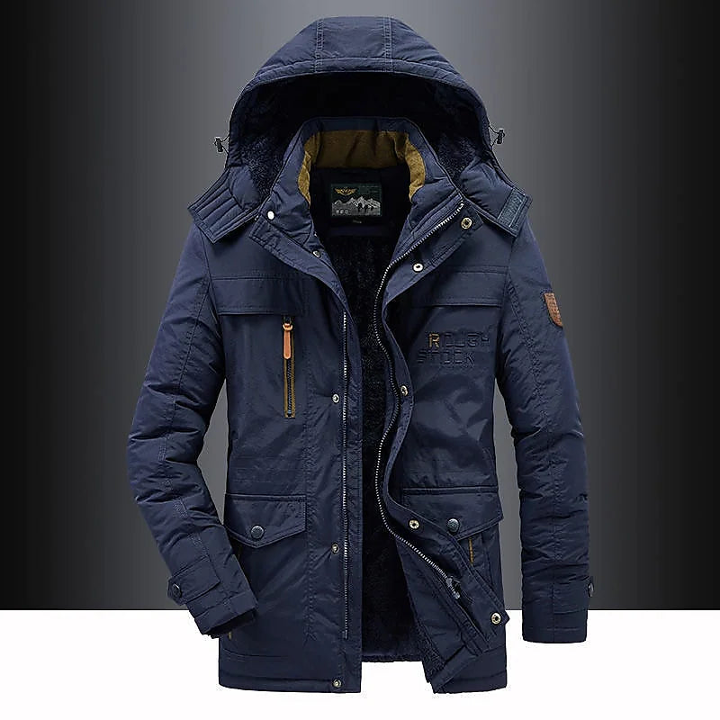 Full shot of man wearing a thigh-length hooded parka, suitable for severe winter conditions