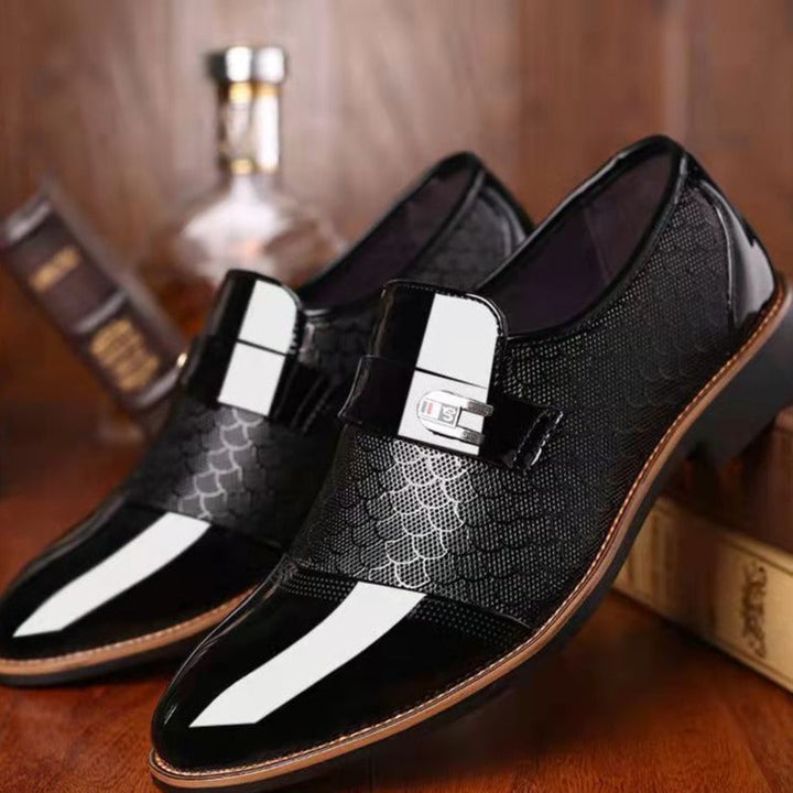 Close-up of men's classic black leather dress shoes, highlighting the genuine leather texture & stitching
