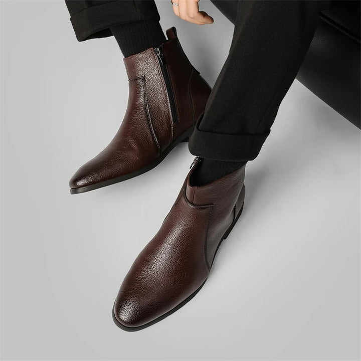 Close-up of men's genuine leather ankle boots with a sleek side zipper and pointed toe design