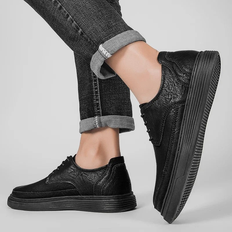 Front view of men's leather dress sneaker, featuring classic laces and a polished finish.