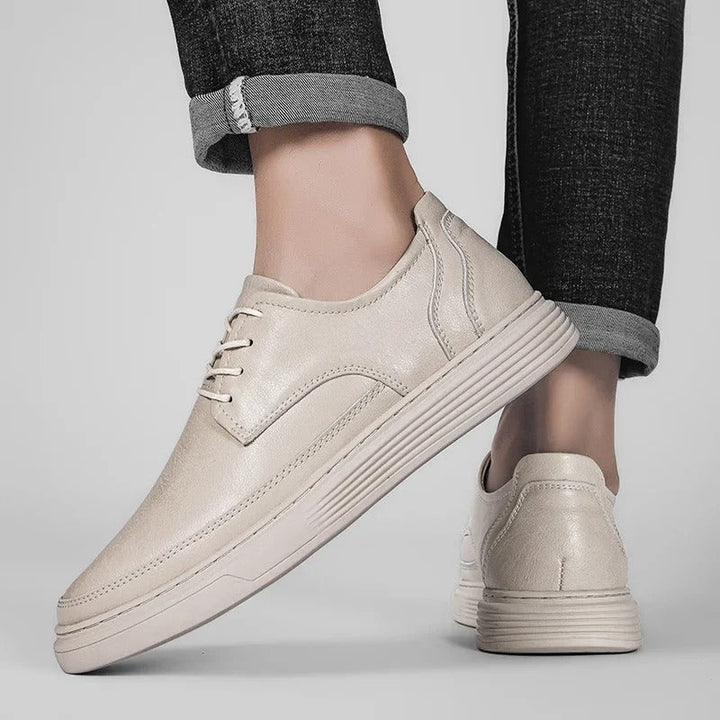 Close-up of the stitching and craftsmanship on a men's premium leather dress sneaker hybrid.