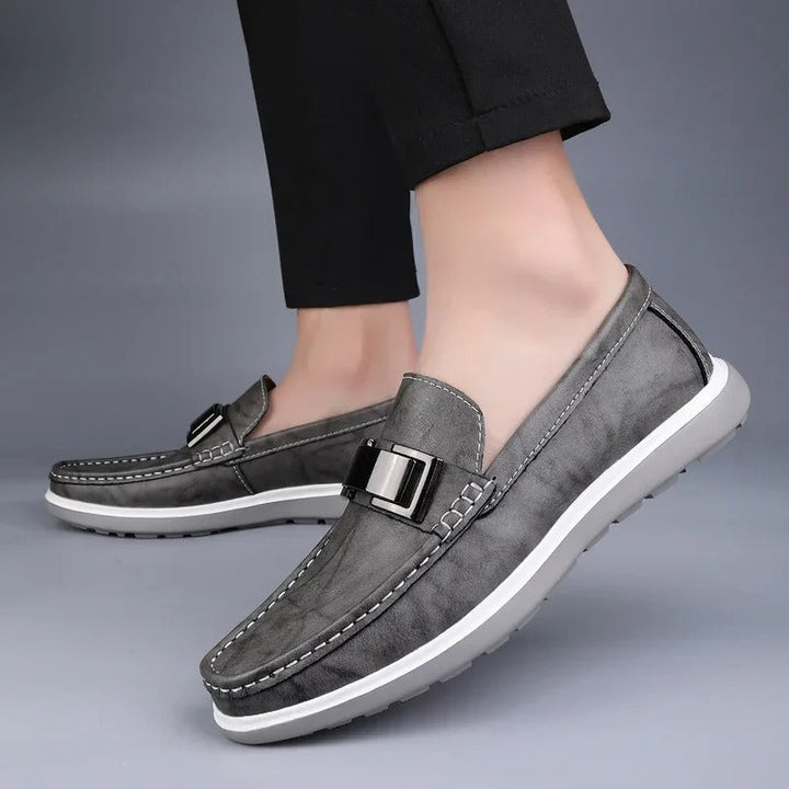 Back view of men's leather loafer, showing heel support and overall shape.