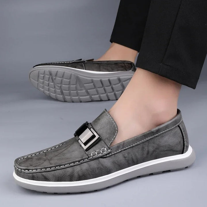 Men's casual leather loafers in black, brown, and gray, a versatile collection.