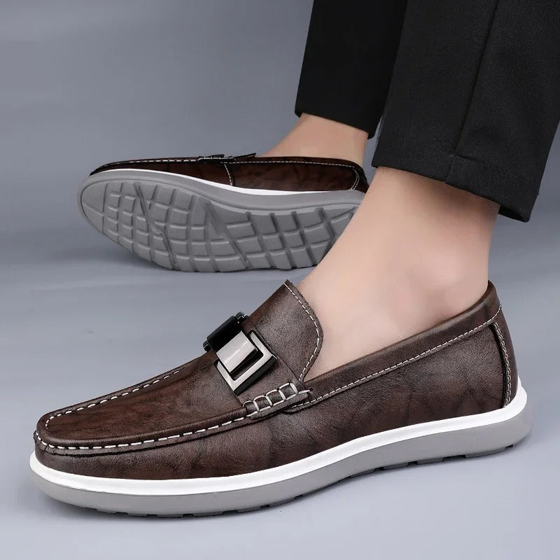 Close-up of the textured leather on a men's casual loafer, showcasing quality.