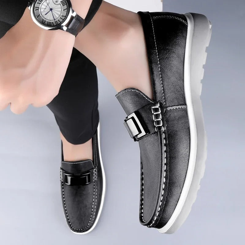 Top-down view of men's black leather slip-on loafers, elegant and practical.