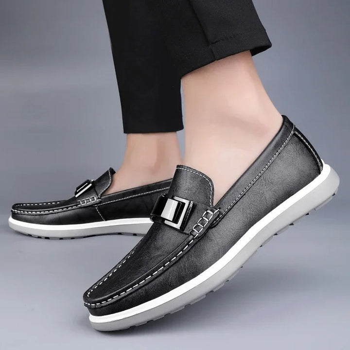 Pair of men's brown leather loafers, presented neatly, ideal for casual outfits.