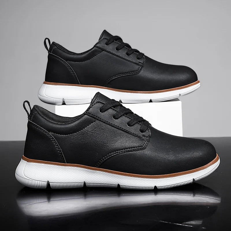 Pair of black leather lace-up sneakers for men, offering both comfort and versatile style for daily fashion.