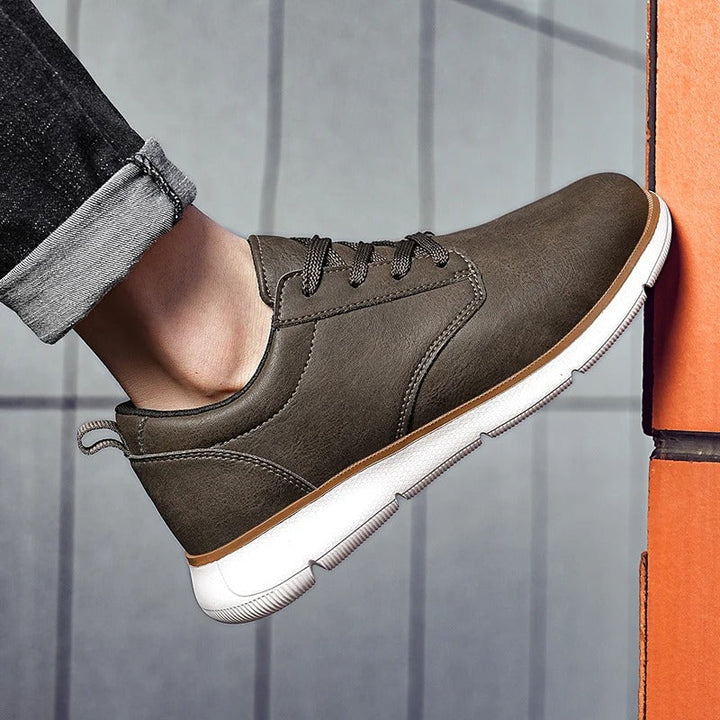 Men's casual leather sneakers in black and brown, displayed together to show color options and versatile style.