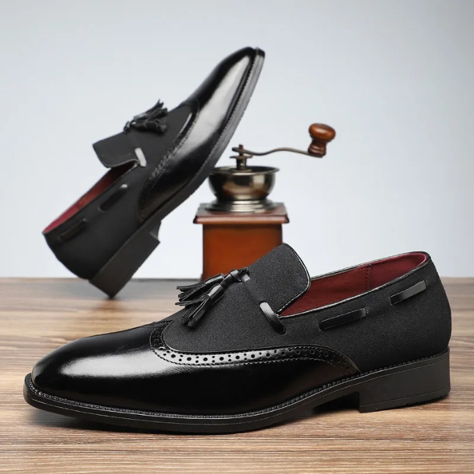 Classic men's fashion: dark blue leather tassel loafers with subtle brogue for a refined look