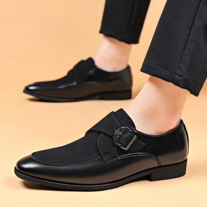 Close-up of black men's luxury leather & suede loafers, highlighting the blend of textures.