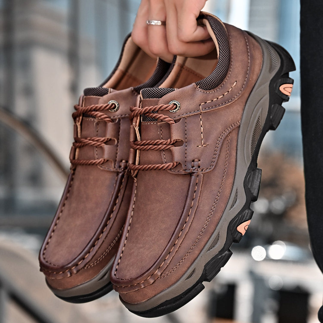 Pair of men's orthopedic casual loafers in dark brown, featuring lace-up design and arch support