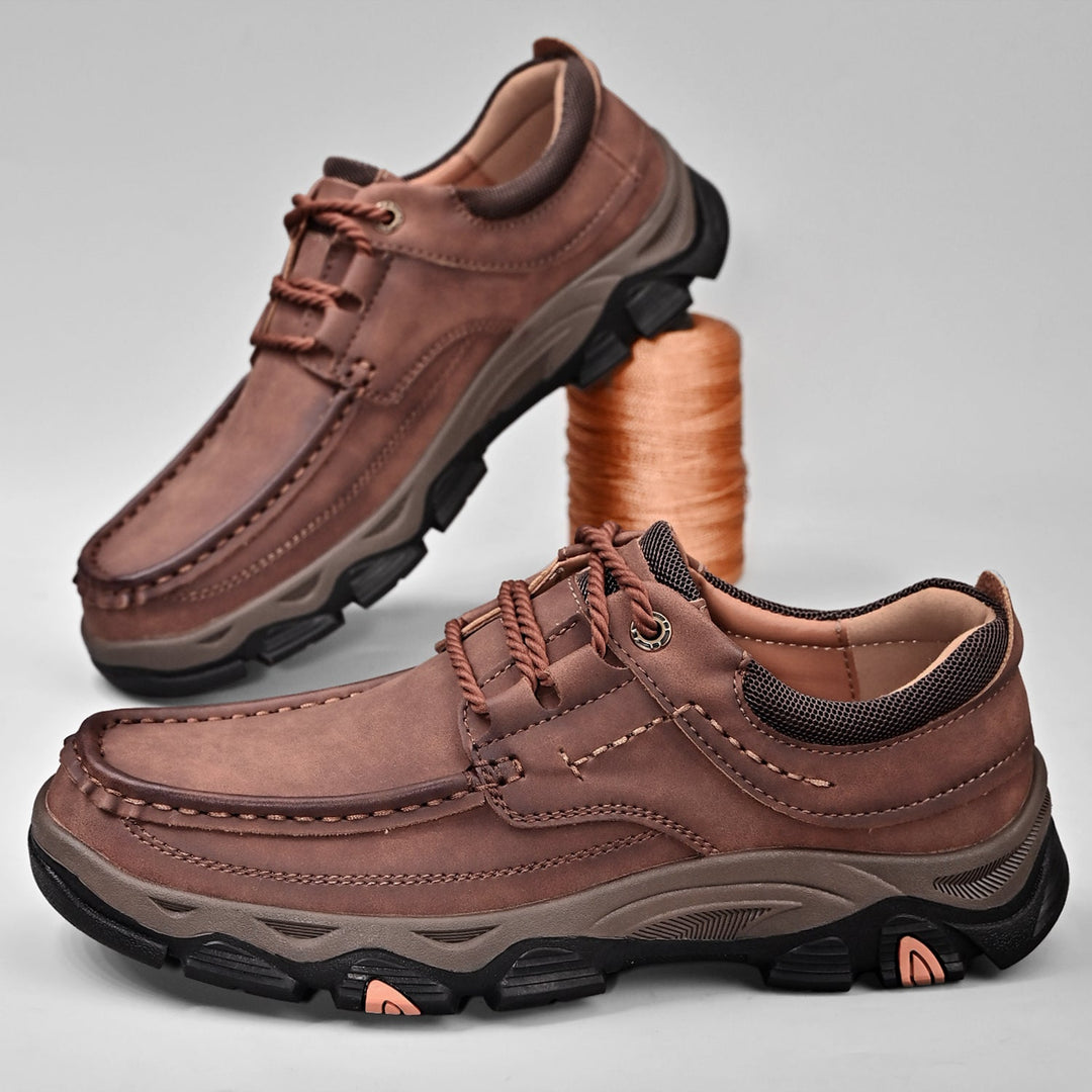 Men's orthopedic casual loafers in a deep blue, showing laces and arch support for active comfort