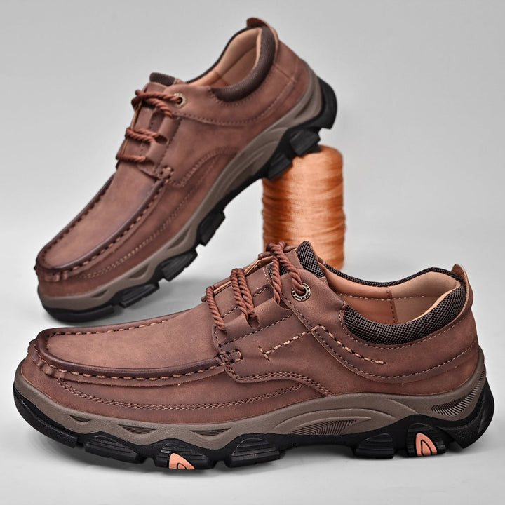 Men's orthopedic casual loafers in a deep blue, showing laces and arch support for active comfort