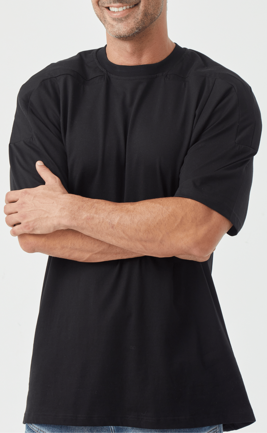 Lifestyle shot of a man in a white padded shoulder muscle tee, ideal for casual outfits.