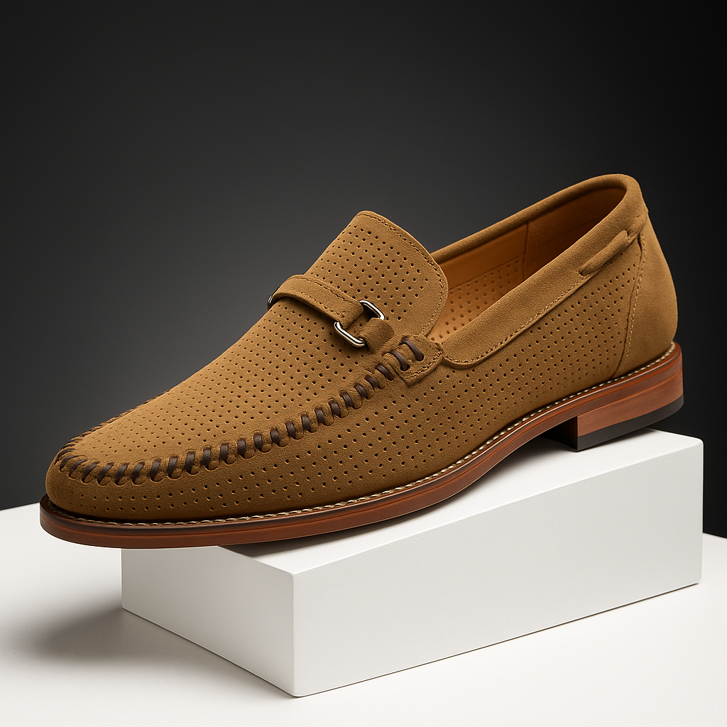 Close-up of men's slip-on loafer with perforated detail and silver buckle