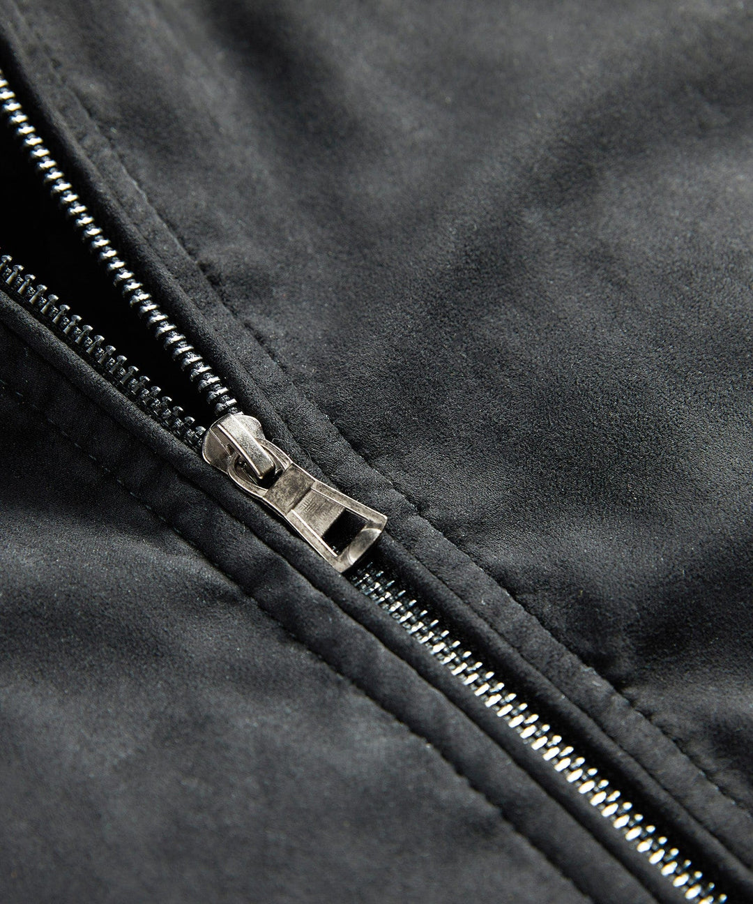 Side profile of a men's black quilted jacket, showcasing the trendy sherpa collar and bomber style.