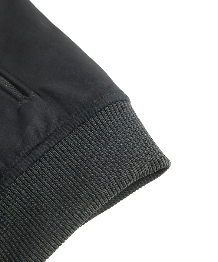 Back view of a men's black quilted bomber jacket, highlighting the comfortable winter apparel design.