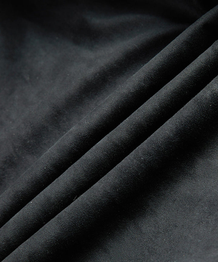Detail of the quilting on a men's black bomber jacket, paired with a plush sherpa collar.