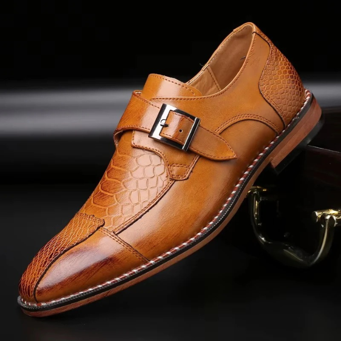 Close-up of the luxurious reptile texture on men's black monk strap leather dress shoes.
