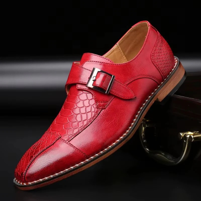 Men's statement reptile-textured monk strap luxury footwear paired with formal attire.