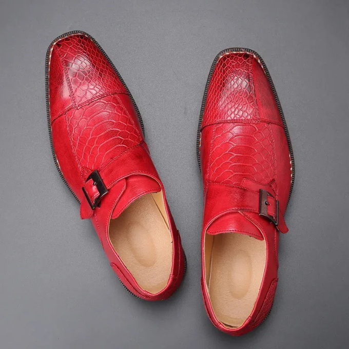 Top-down view of men's sleek black reptile-textured monk strap dress shoes, elegant design.