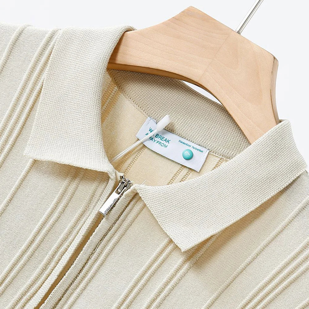 Detail of the zipper and collar on a men's black ribbed knit smart casual polo shirt.