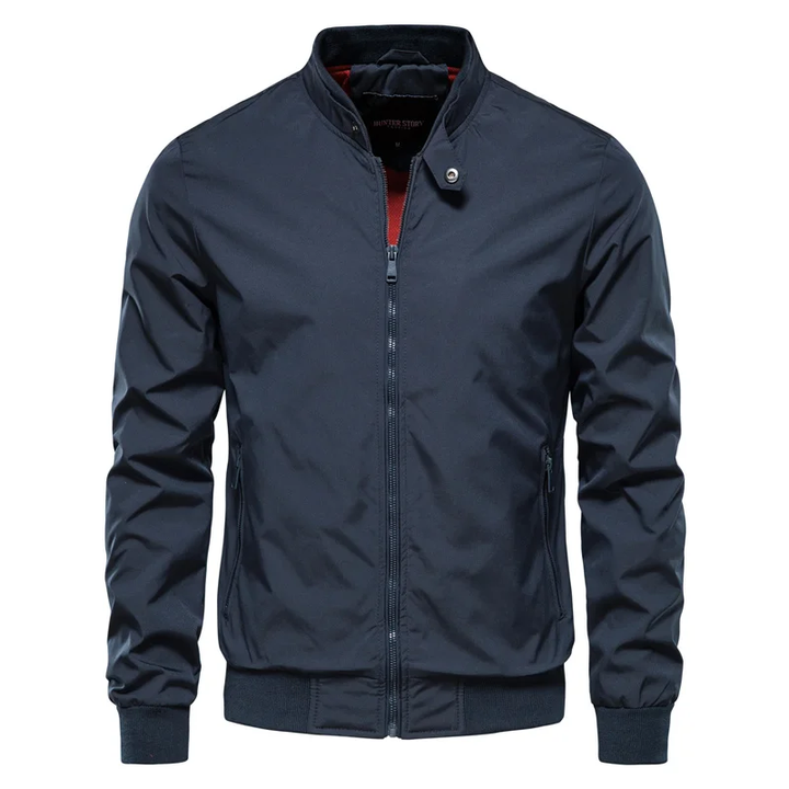 Young man wearing a stylish blue urban streetwear zip jacket, side view. Perfect for casual men's fashion.