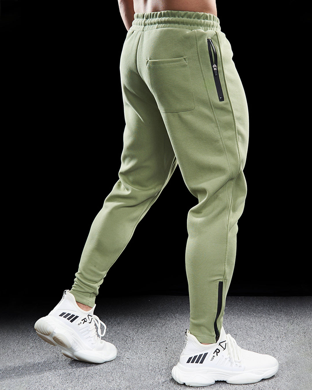 Men's black tapered track joggers with zippered hems, side pockets, and elastic waistband, ideal for workouts.