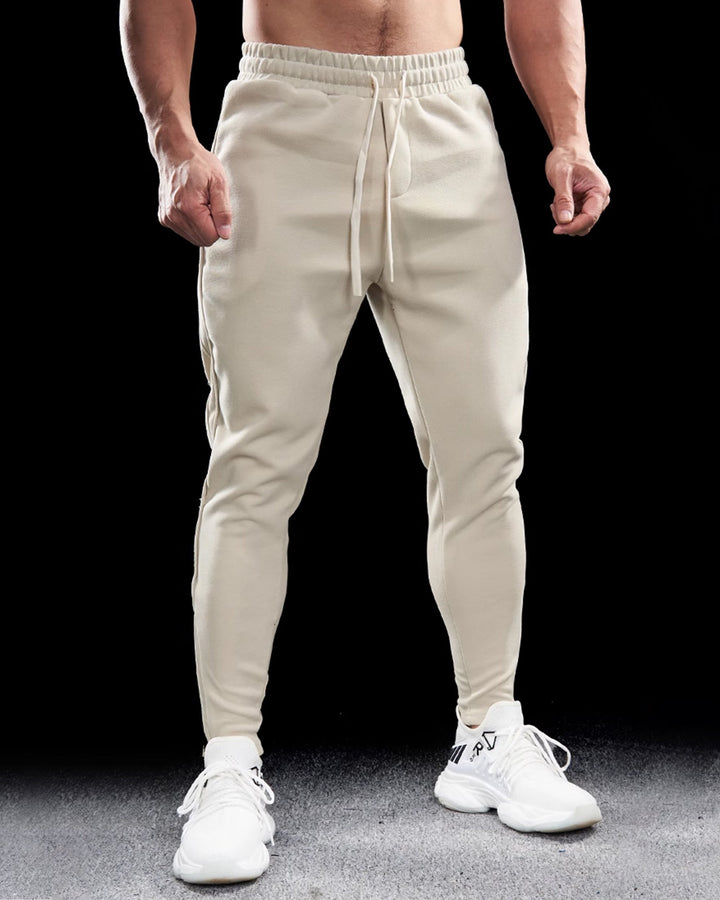 Men's active sweatpants with a modern tapered cut, elastic waist, and functional zippered cuffs.