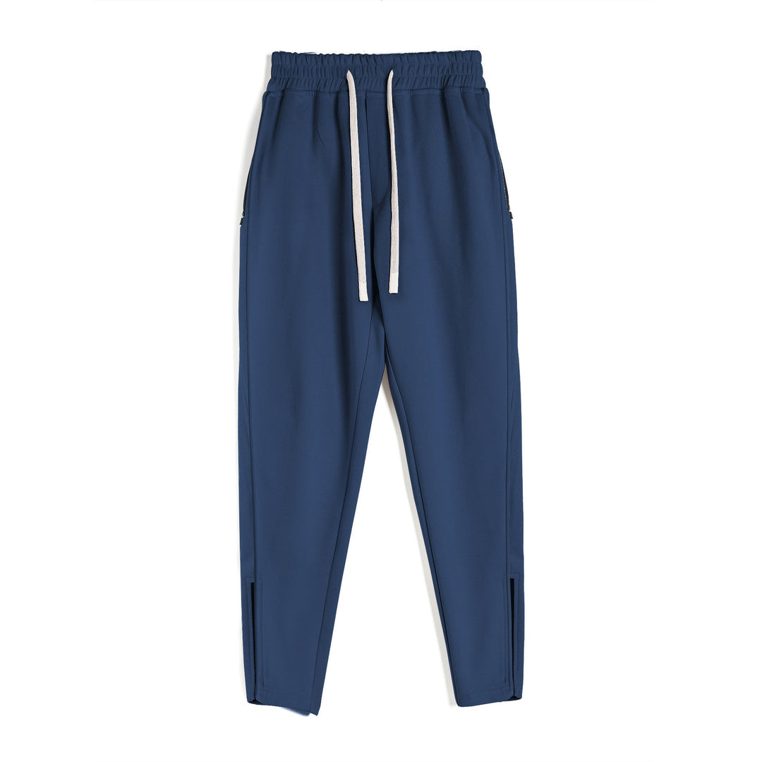 Side profile of men's athletic sweatpants, tapered design, zippered ankle, versatile for gym or daily use.
