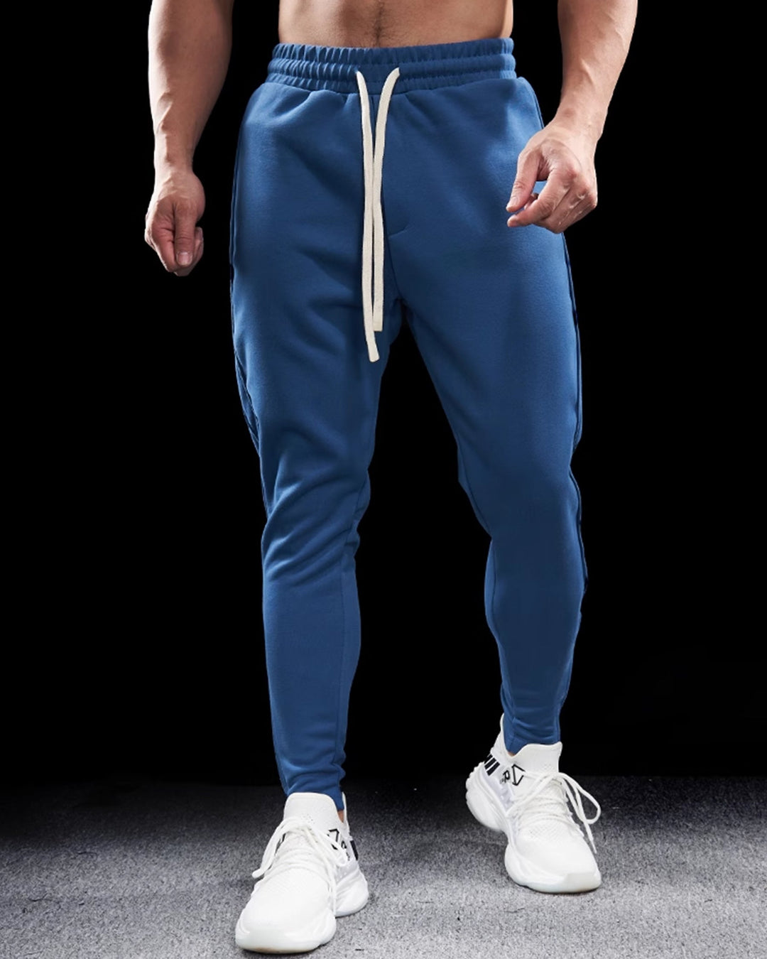 Rear view of men's tapered joggers with zippered hems, highlighting the streamlined athletic pant design.