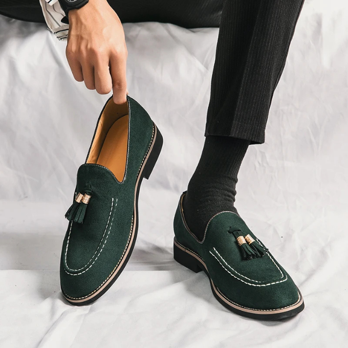 Ground-level view of men's velvet tassel loafers, highlighting sole and upper