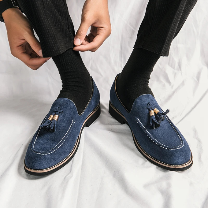 Detailed shot of the velvet texture and tassel design on men's dress loafers