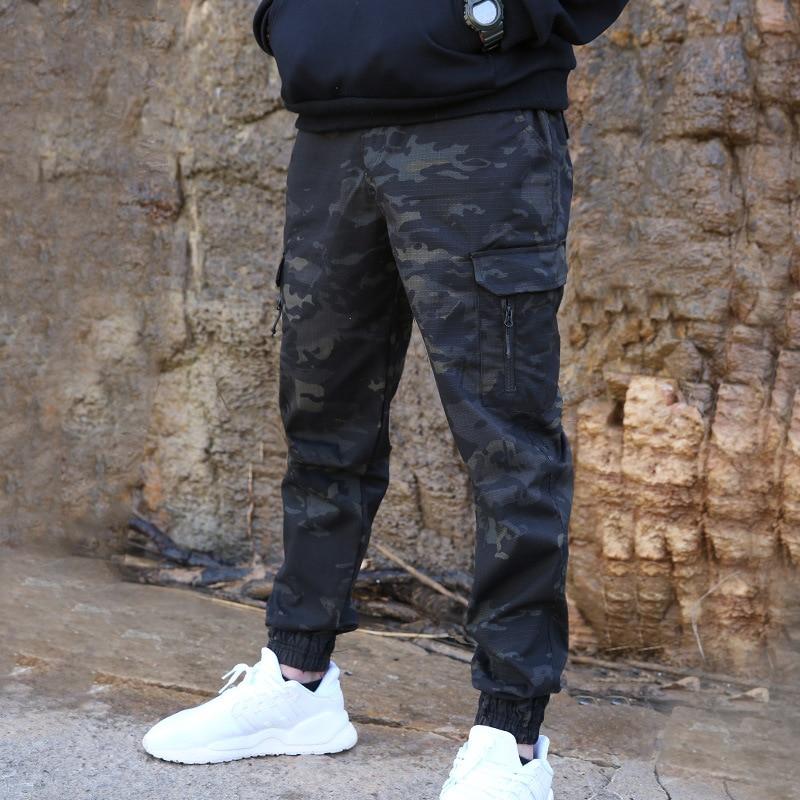 Close-up of the waterproof fabric on men's tech jogger pants, showing texture and quality