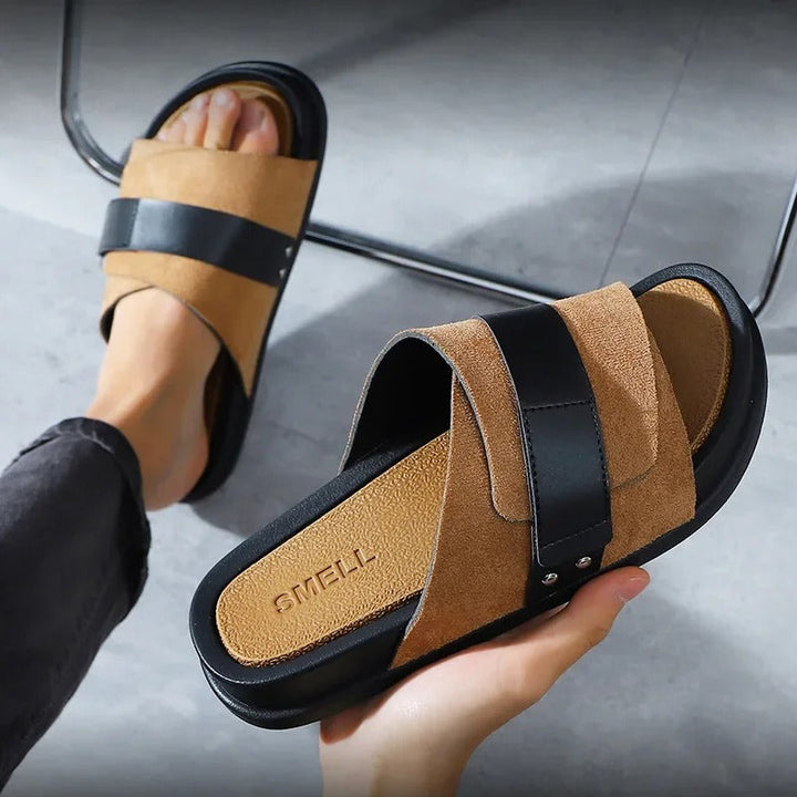 Pair of men's brown suede slip-on sandals, top view, highlighting rich texture and wide strap