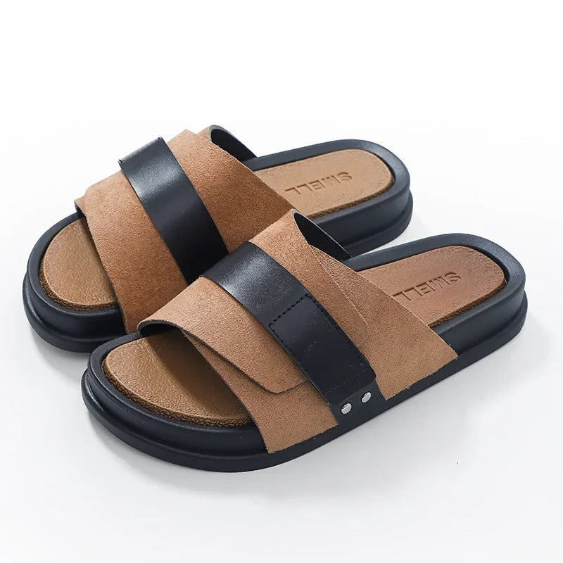 Studio shot of men's black suede slides, showcasing durable sole and stylish design