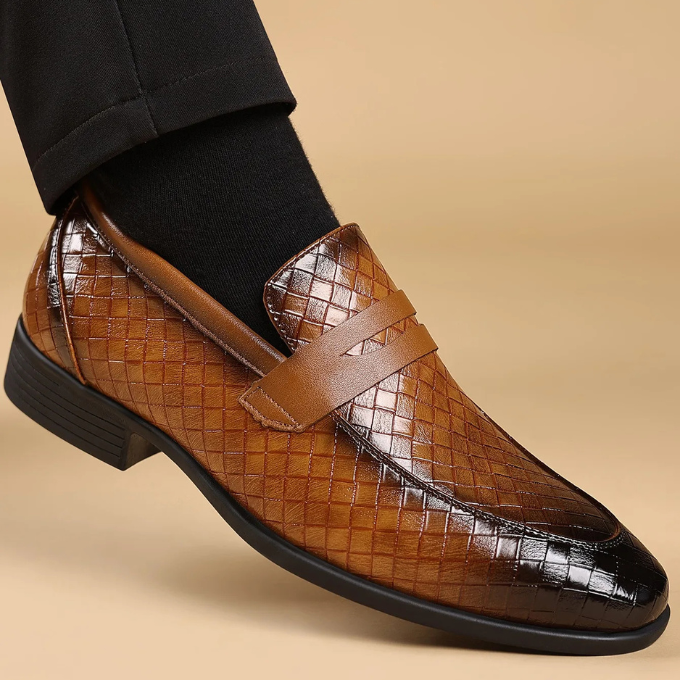Side view of a men's woven leather loafer, showcasing the slip-on design and durable sole.