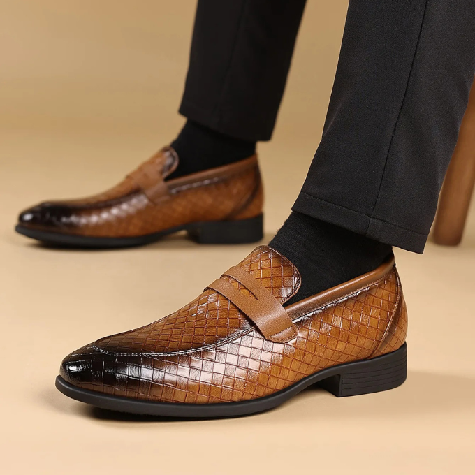 Top-down shot of elegant black woven leather loafers, suitable for casual or dress occasions.