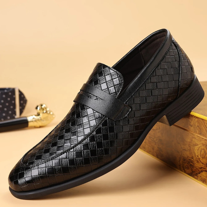 Men's black leather loafers with a distinct woven pattern, a versatile and stylish footwear choice.