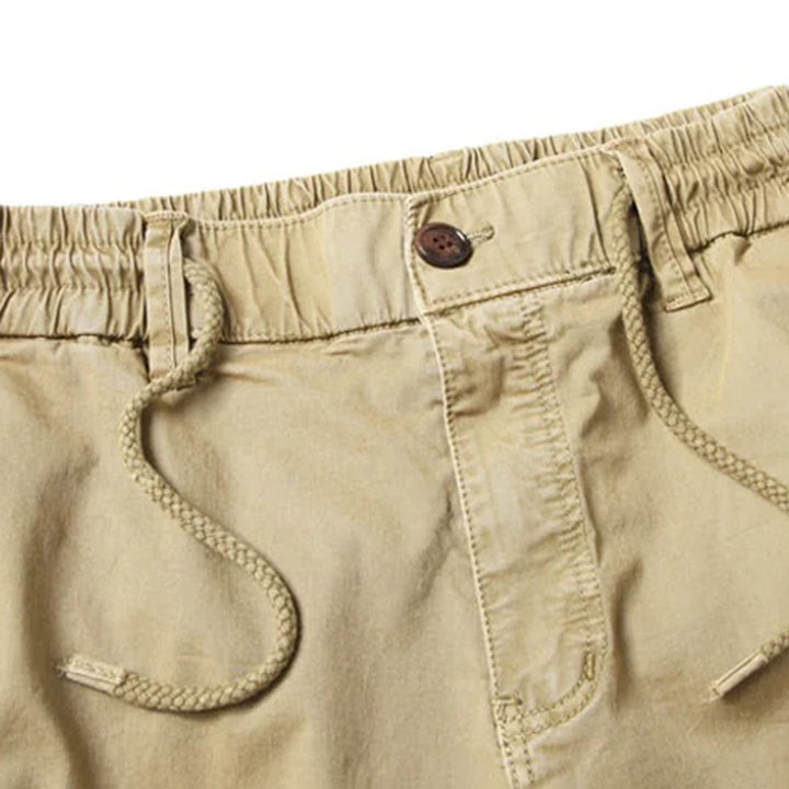 Side view of navy blue men's jogger pants, highlighting the tapered leg and pocket detail.