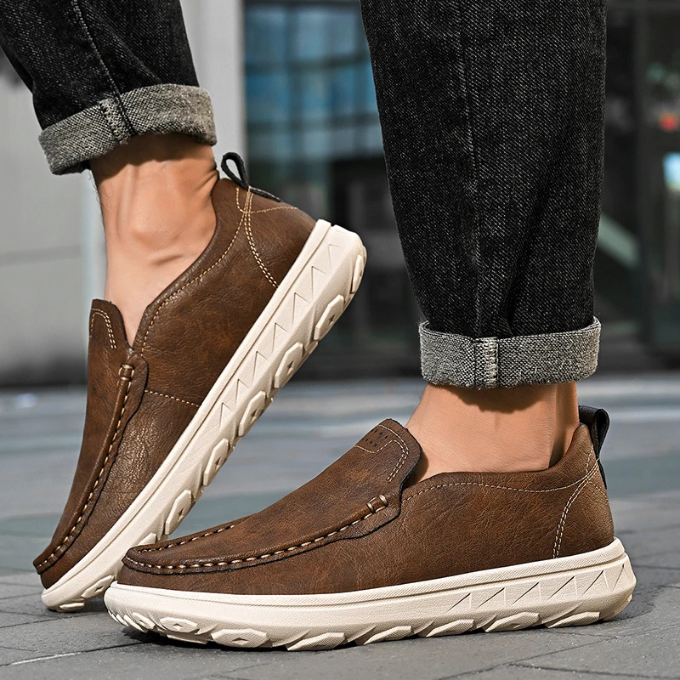 Side view of a men's casual grey slip-on loafer, comfortable and modern footwear.