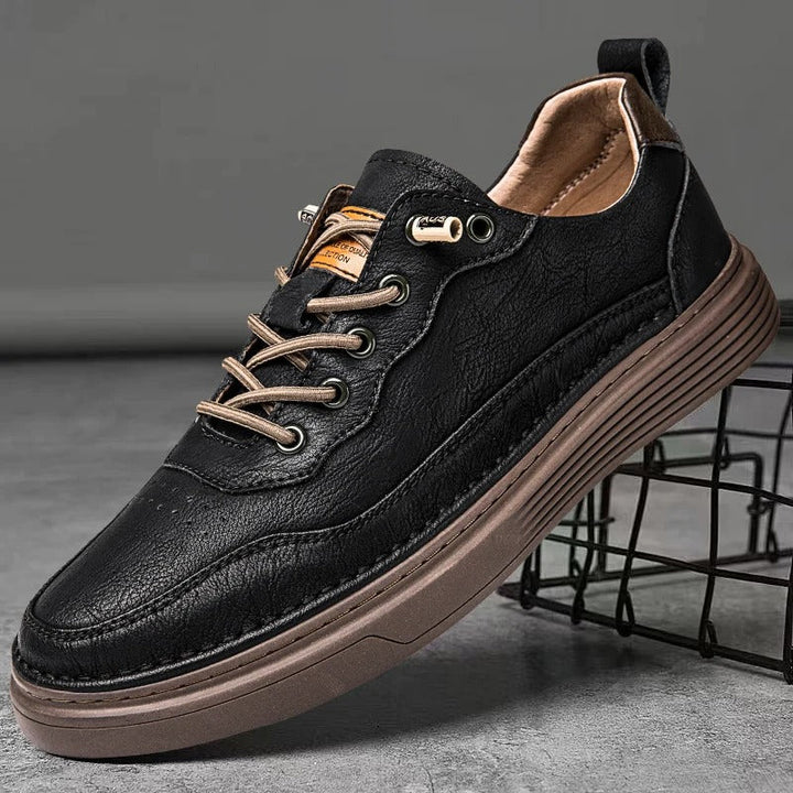 Detail of the stitching on men's brown leather casual sneakers