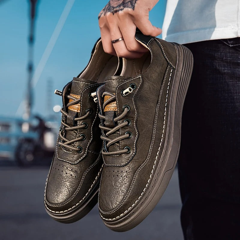 Close-up of the textured brown leather on men's casual sneakers
