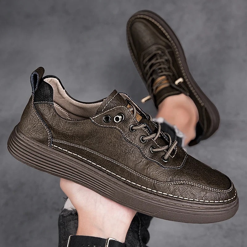 Top-down view of black men's casual leather sneakers, sleek design