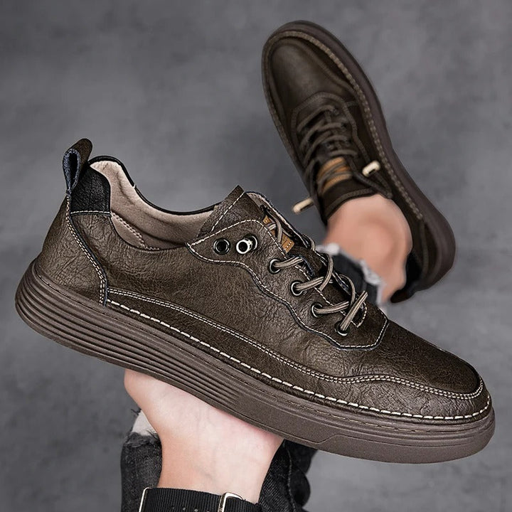 Top-down view of black men's casual leather sneakers, sleek design
